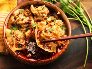 Bowl of Sichuan-style wontons in hot and sour vinegar and chili oil sauce