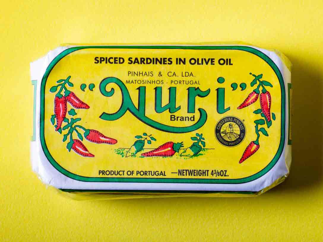 A closeup of a can of Nuri Spiced Sardines in Olive Oil.