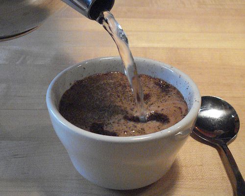 pouring water on coffee grounds