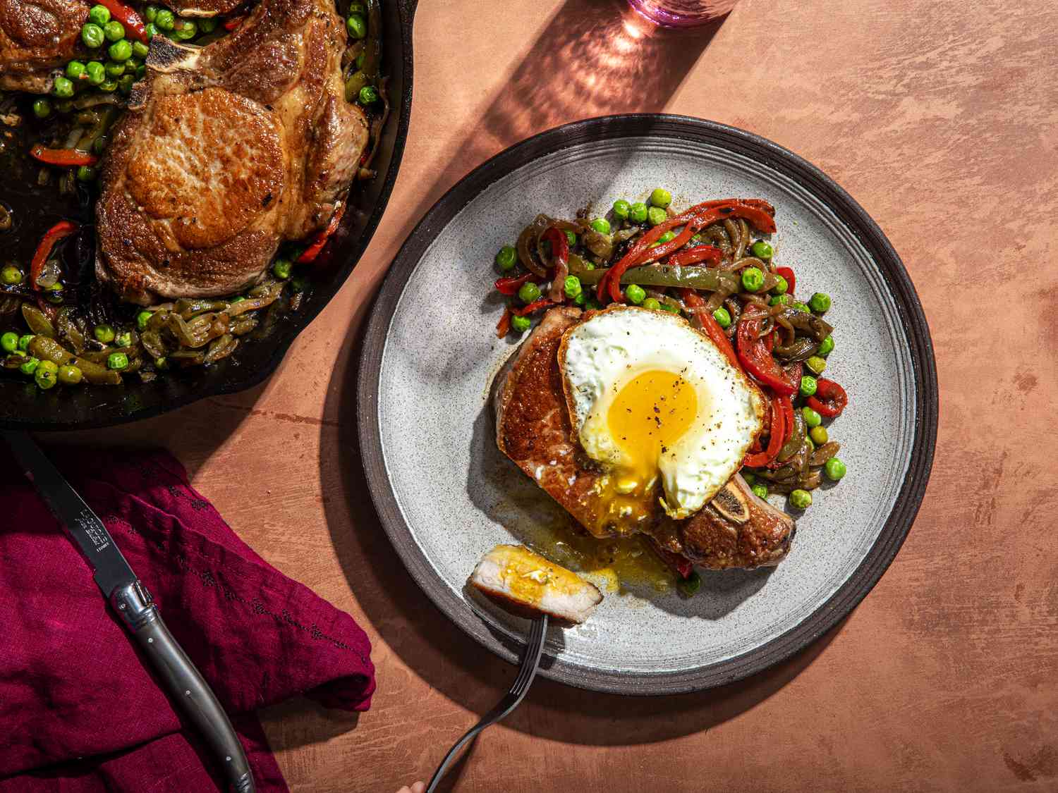 Overhead view of a plate of Costillas a la Riojana with an egg on top