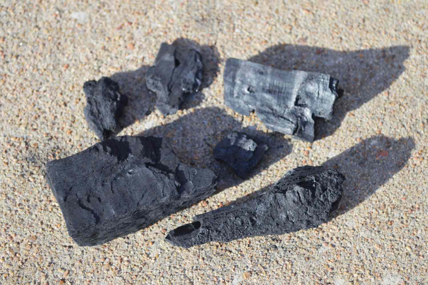 a closeup look at different sized pieces of lump charcoal