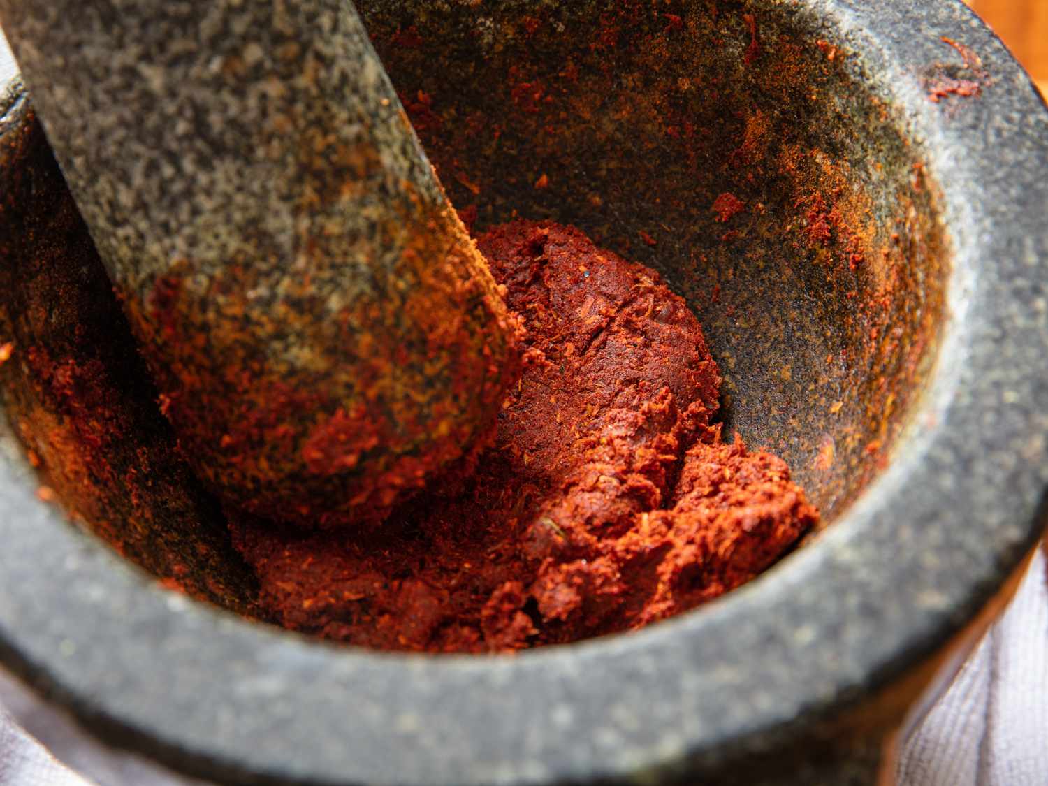 a close up of massaman curry paste in a mortar and pestle