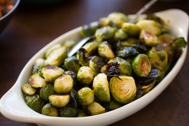 Pan-roasted Brussels sprouts in a white serving dish