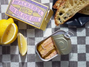 Siesta co mackerel tin open with bread and lemon wedge