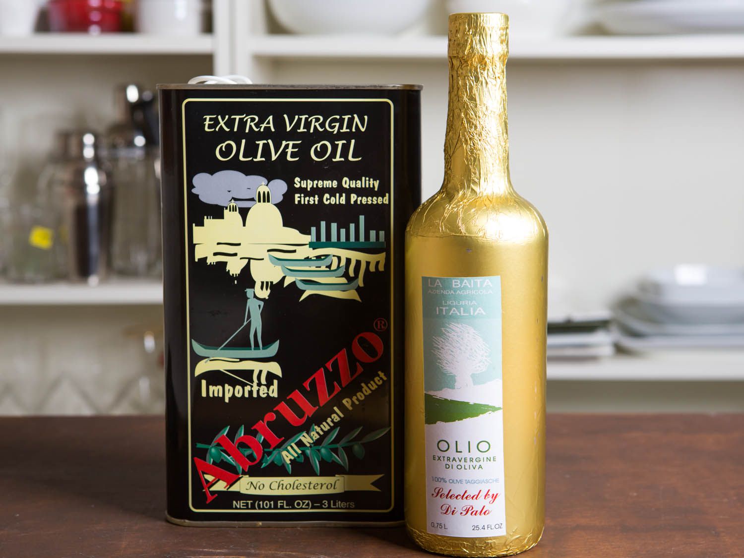 Can of olive oil next to bottle of olive oil on a table