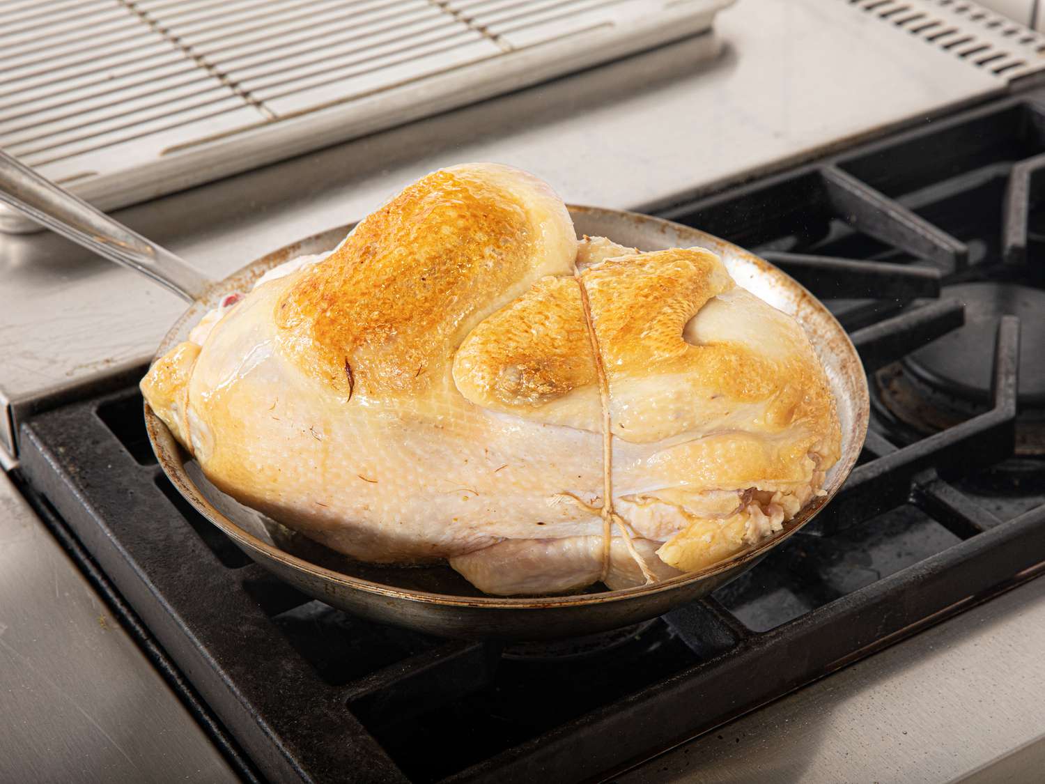 Overhead view of browning chicken in a pan