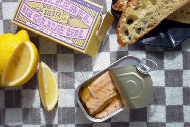 Siesta co mackerel tin open with bread and lemon wedge