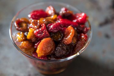 a bowl of red and yellow oven-roasted tomato raisins