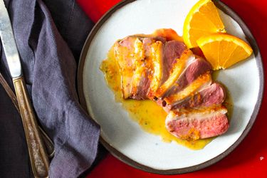 Slices of duck breast drizzled with an orange sauce