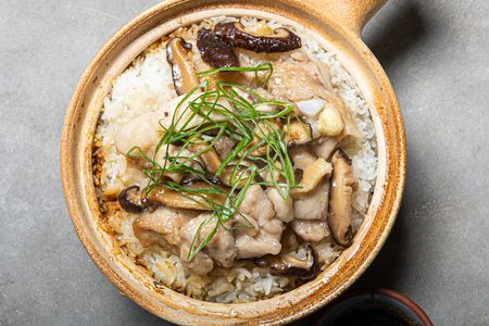 Velveted chicken with mushrooms on top of Cantonese clay pot rice.