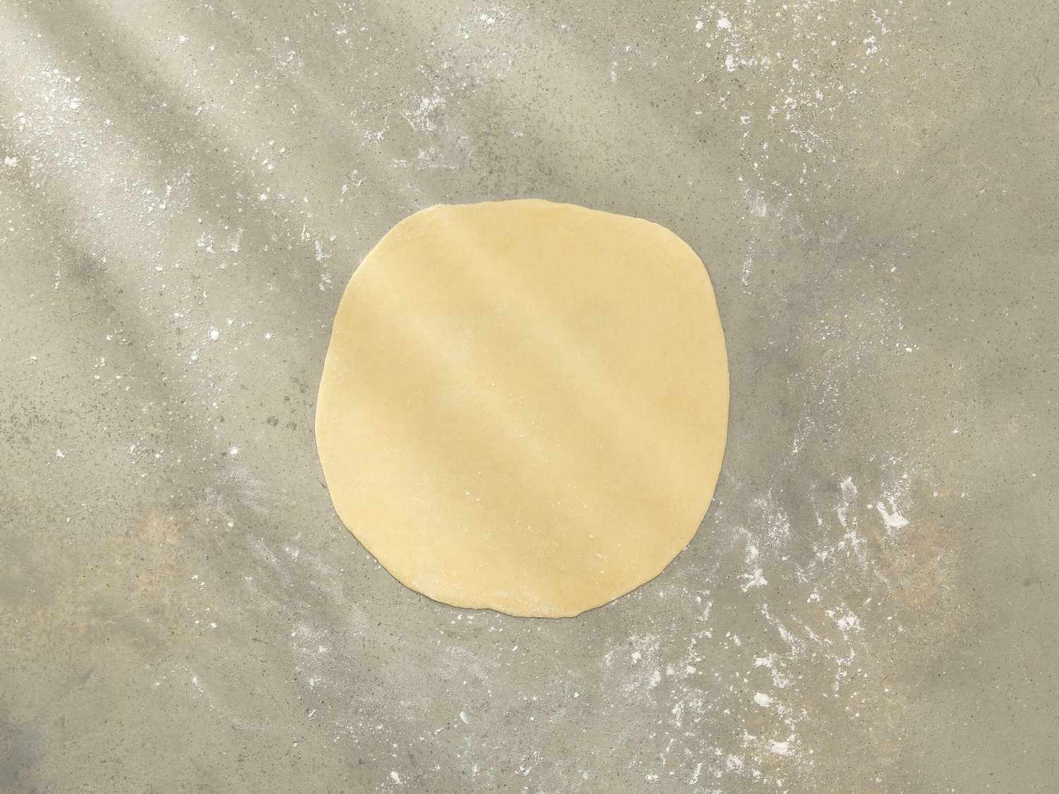 Overhead view of dough rolled out into a disc