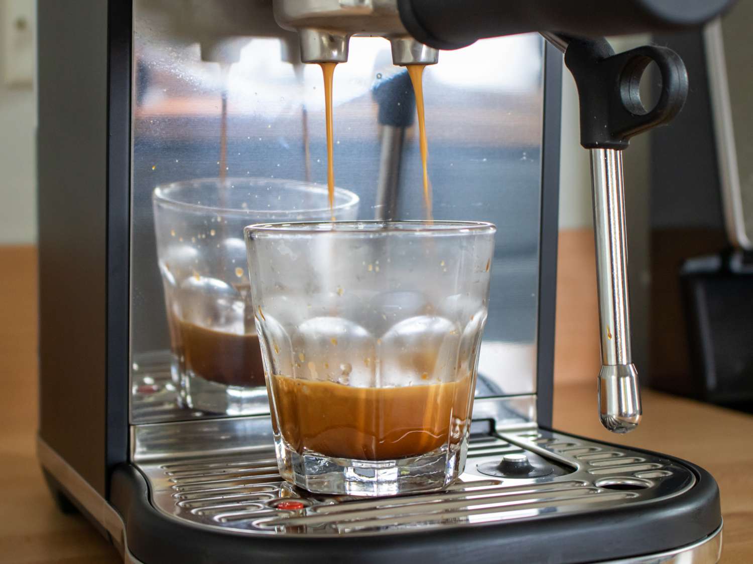 pulling a shot of espresso from the Breville Bambino Plus espresso machine