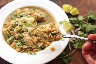 Spoonful of white chicken chili lifted from a bowl