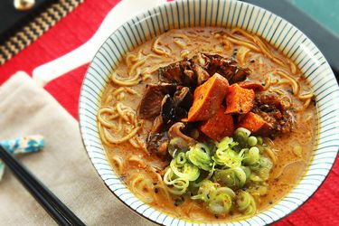 Homemade creamy vegan ramen topped with mushrooms, sweet potatoes, eggplant, and scallions.