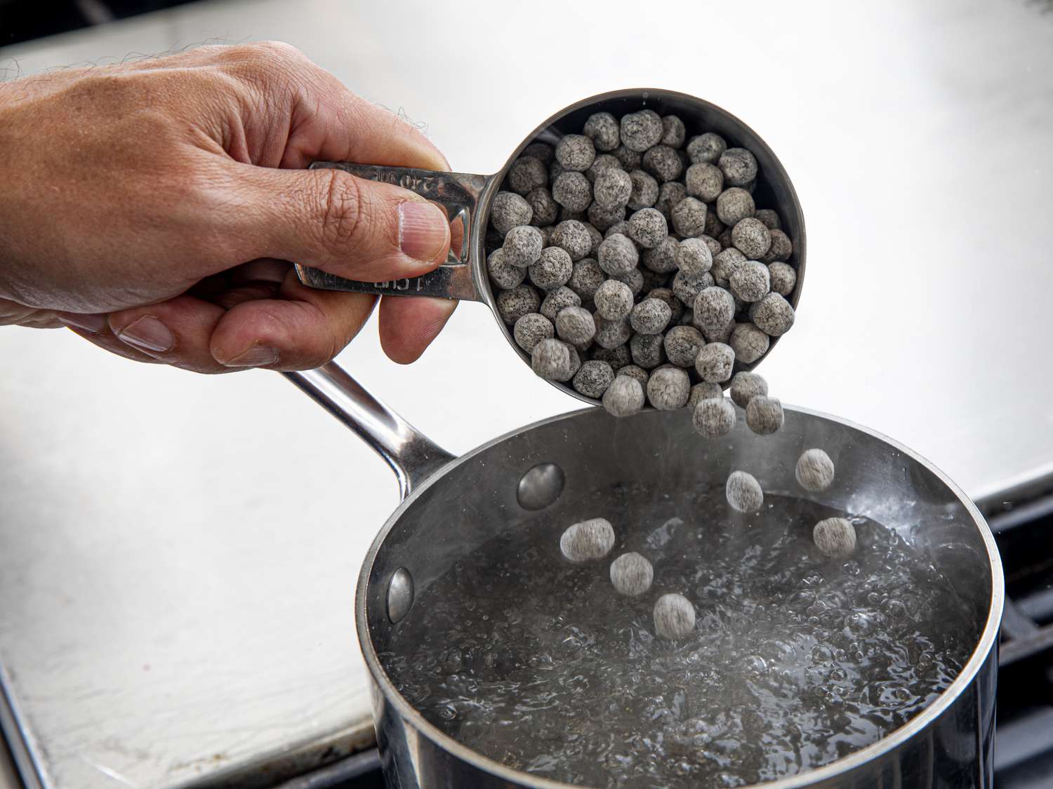 Adding tapioca pearls to boiling pot