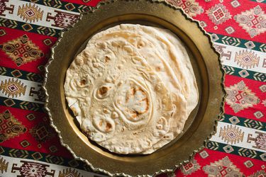 Stack of baked lavash on a serving platter