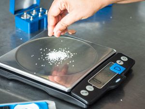 Measuring salt on a digital kitchen scale.