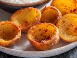 Deep-fried potato-skin cups ready for dipping or filling.