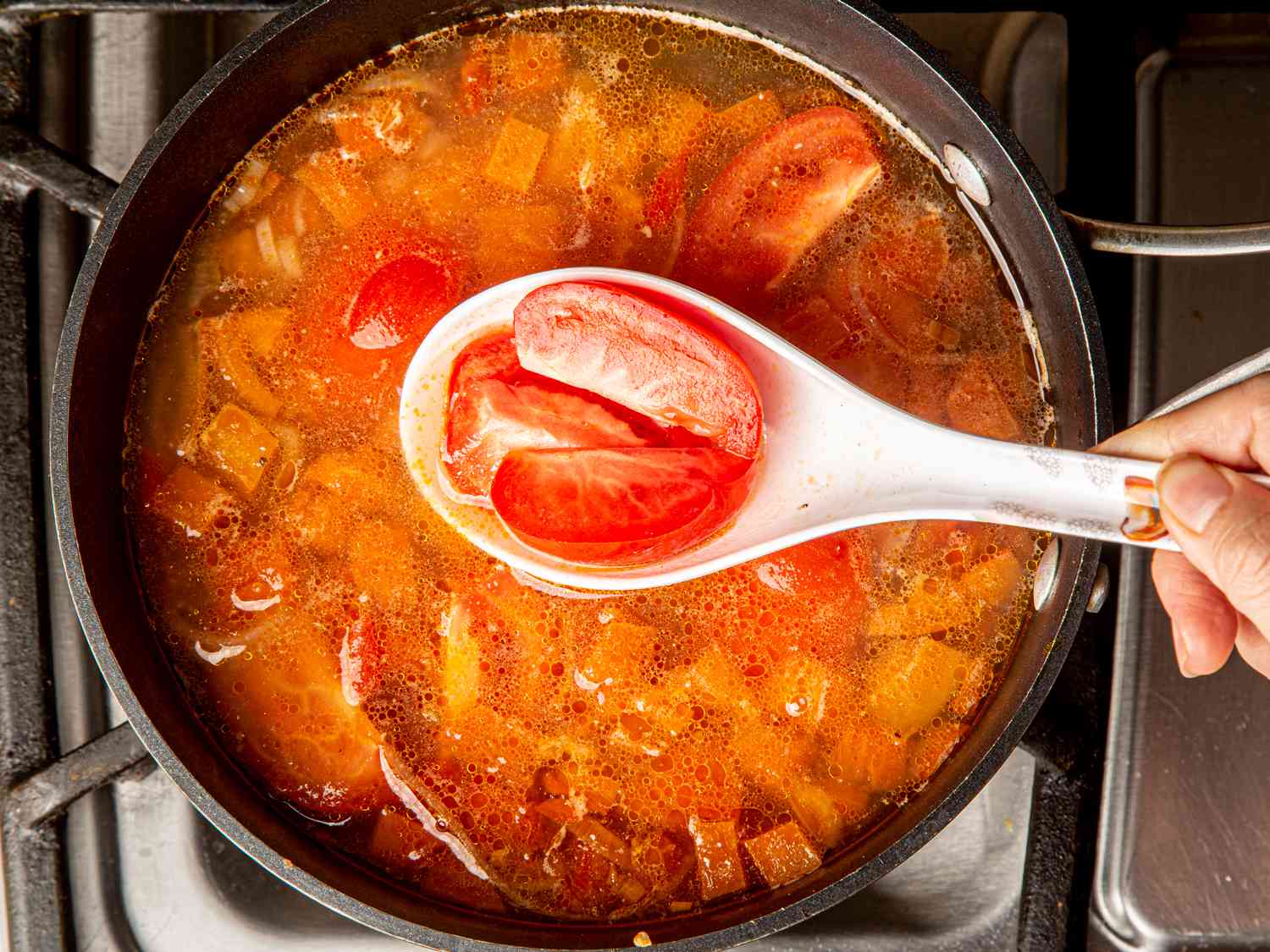 整个西红柿被加入鱼汤的俯视图