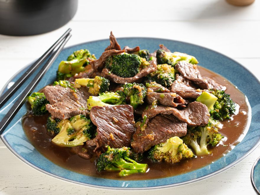 Plate of Stir-Fried Beef with Broccoli in Oyster Sauce with chopsticks resting on the edge