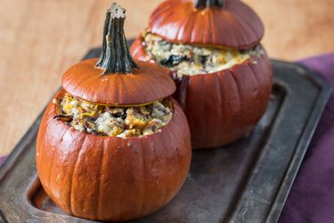 Two stuffed roast pumpkins on a platter