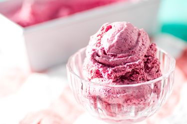 Cherry ice cream in a glass dish.