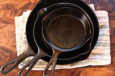 Three cast iron skillets nested for storage