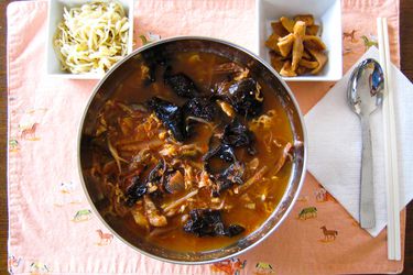 Overhead view of yukgaejang with accompaniments