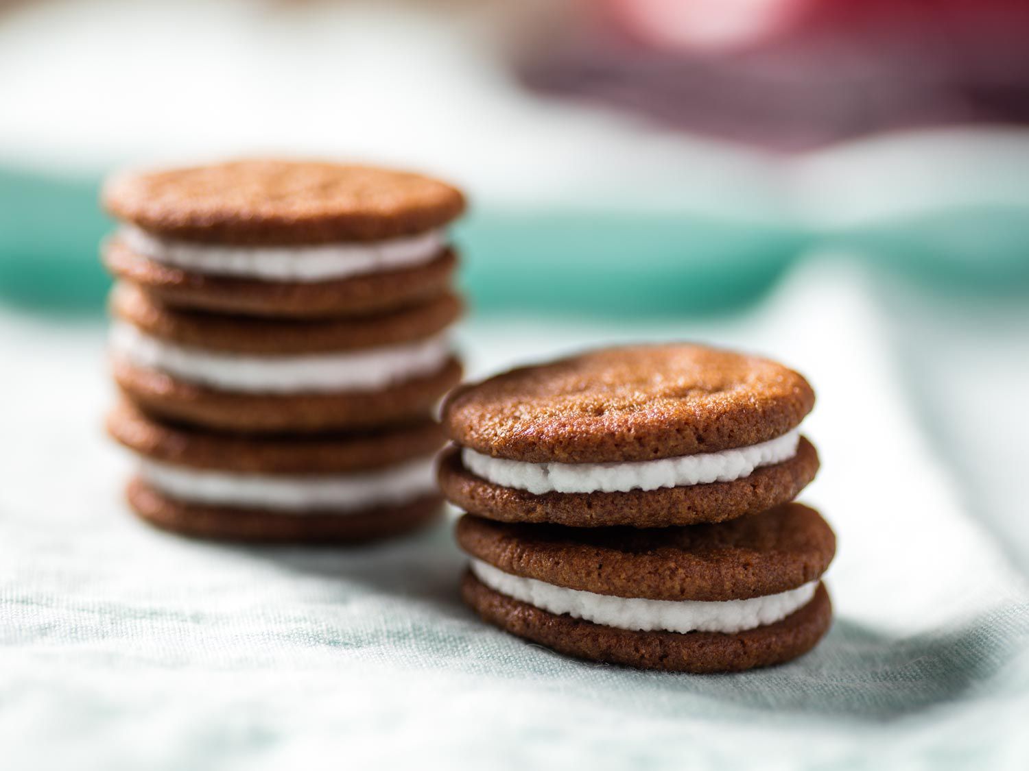 Close-up on two short stacks of lemon-ginger sandwich cookies.