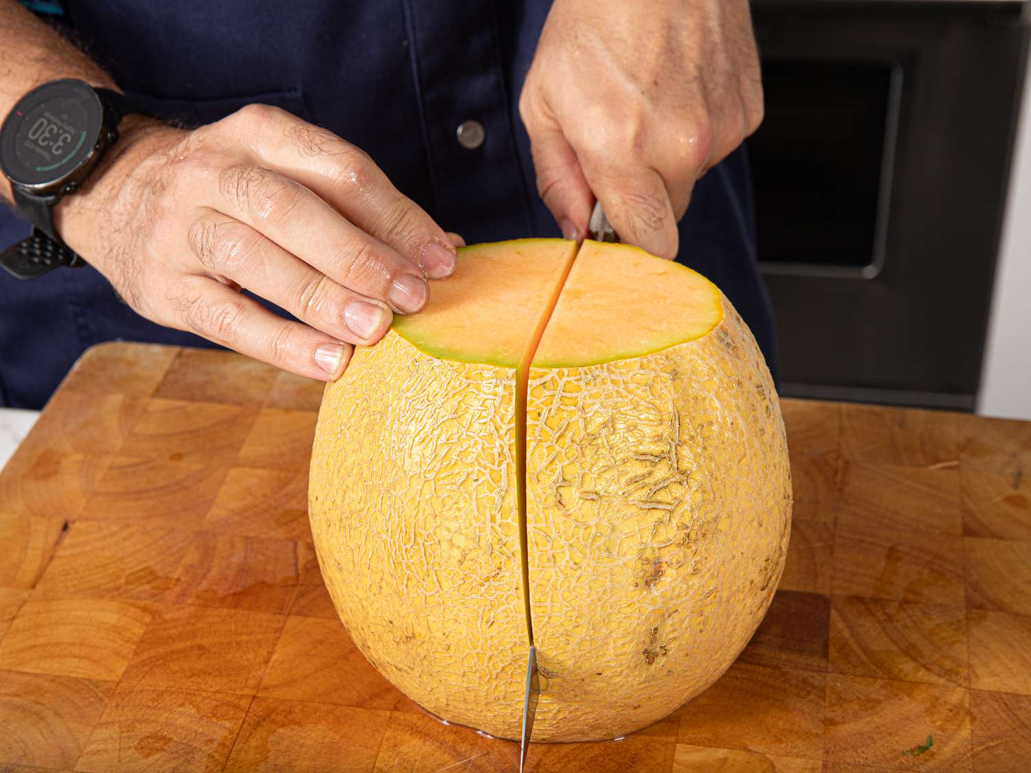 Side angle view of cutting the melon in half