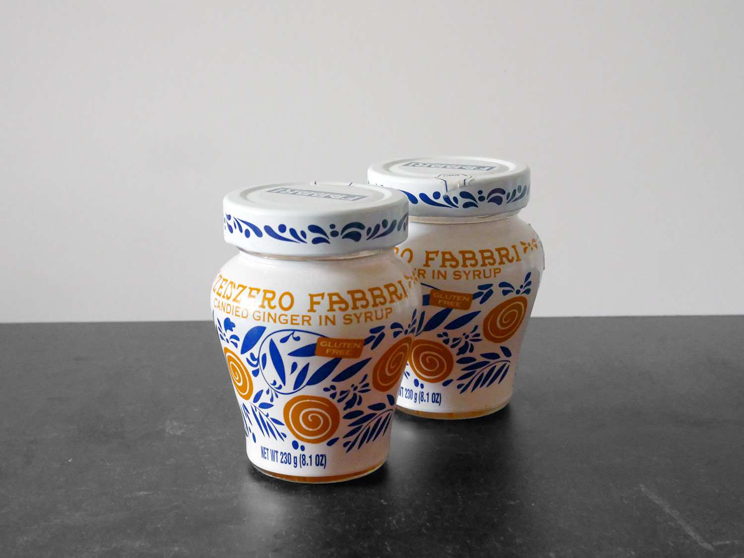 jars of stem ginger on a black countertop