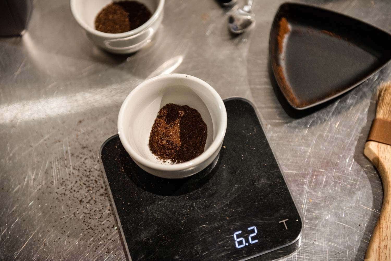 Weighing a portion of sifted coffee grounds