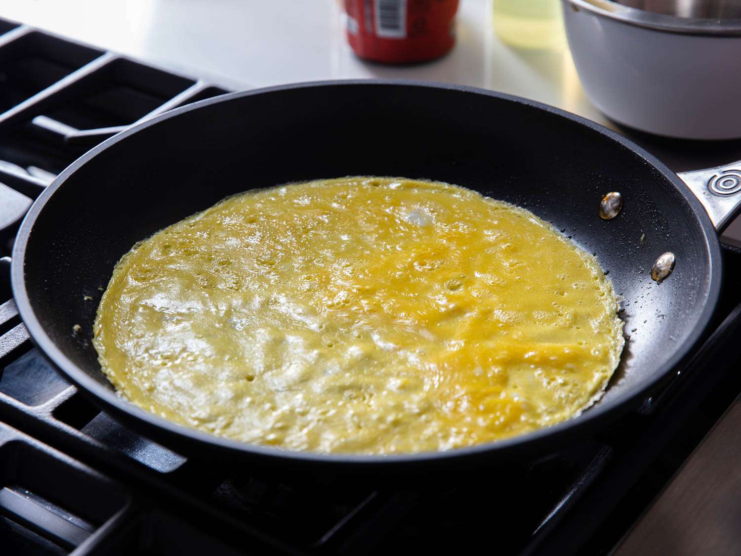 A very thin layer of cooked egg in a nonstick pan on a stovetop.