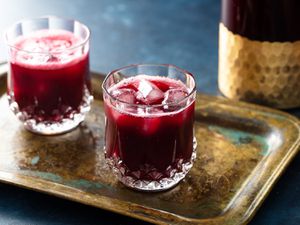 Two Jamaican sorrel hibiscus drinks resting on an old copper platter
