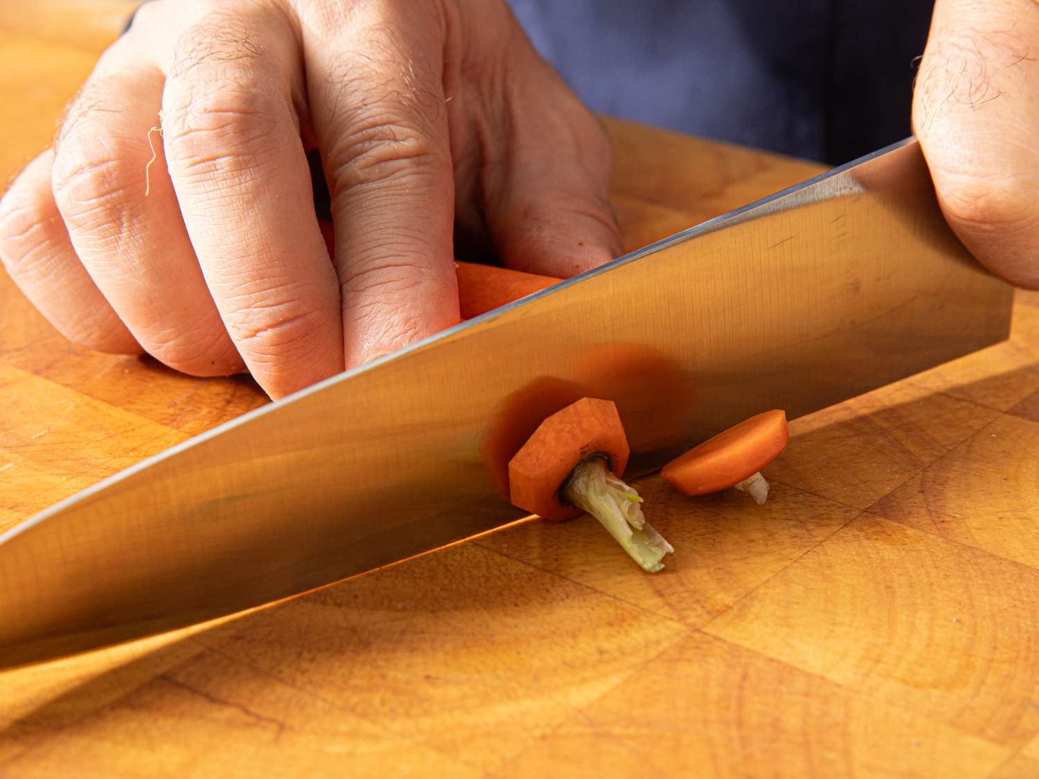 Overhead view of trimming ends off of a carrot