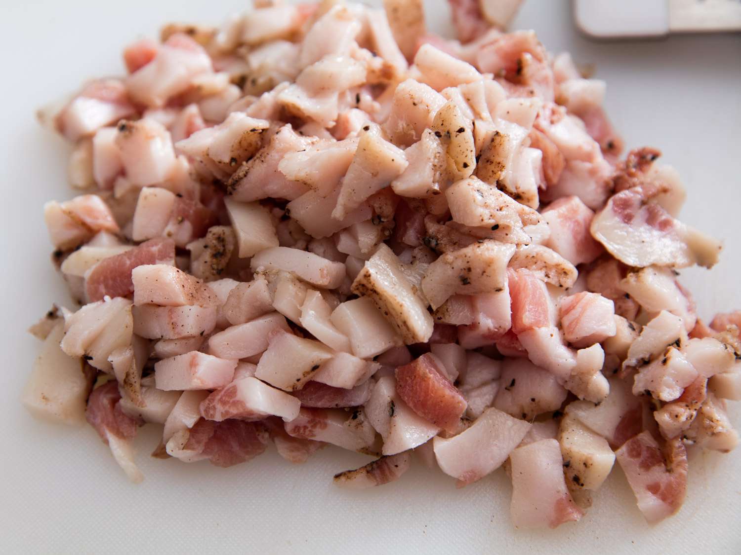 A pile of guanciale cut into thick chunks.