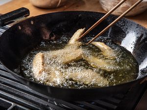 Chicken being deep-fried in a wok