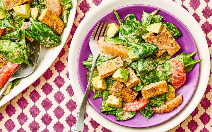 Overhead view of tofu and kale salad with avocado