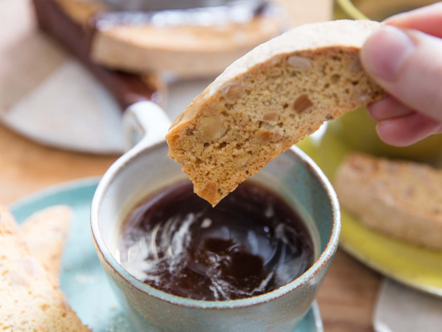 Dunking a biscotti in coffee.