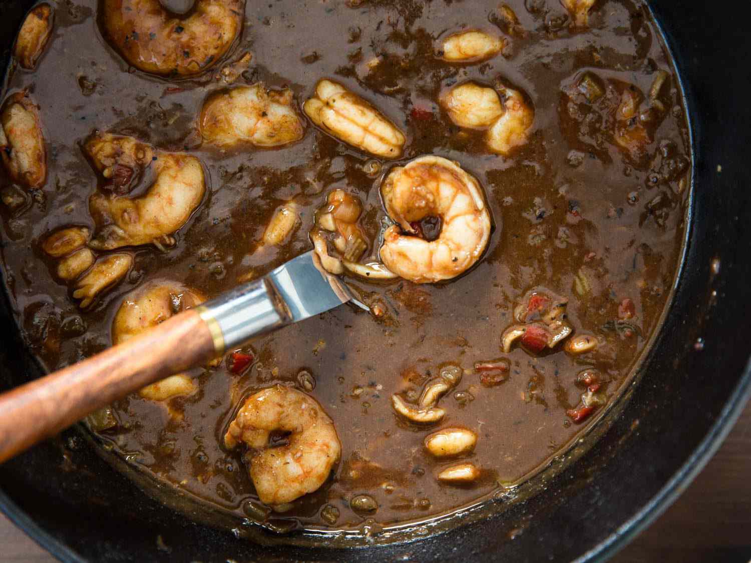 Shrimp etouffee in the pot, made with a dark brown roux.