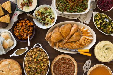 Overhead of a table filled with different Thanksgiving dishes