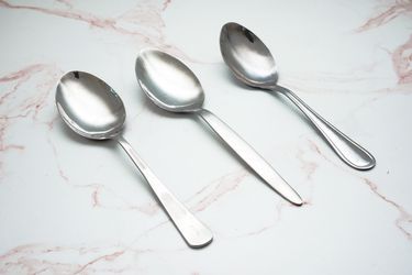 年代auce spoons on a pale pink marble countertop