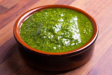 Closeup of a ramekin full of fennel frond pesto.