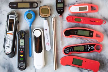 An array of instant-read thermometers on a marble countertop