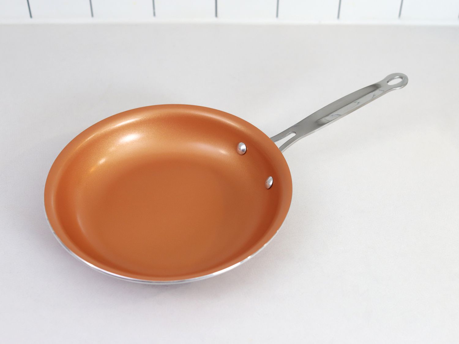 A ceramic nonstick skillet sitting on a white countertop