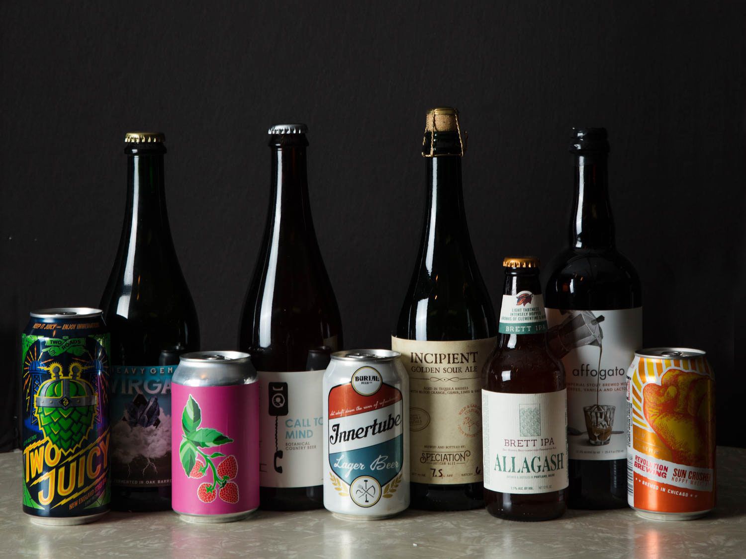 An assortment of beers in bottles and cans.