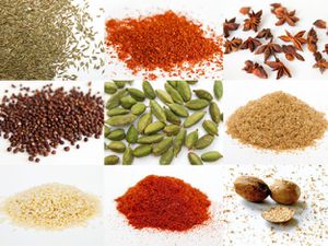 A collage of nine spices commonly used in Indian cooking, including cumin seed, star anise, brown mustard seeds, green cardamom pods, amchoor or mango powder, and whole nutmeg.