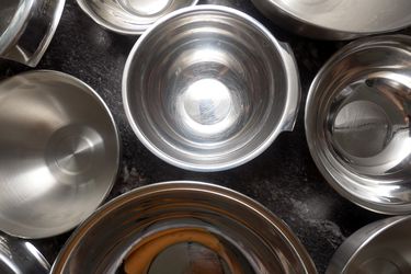 overhead shot of various mixing bowls on a black countertop