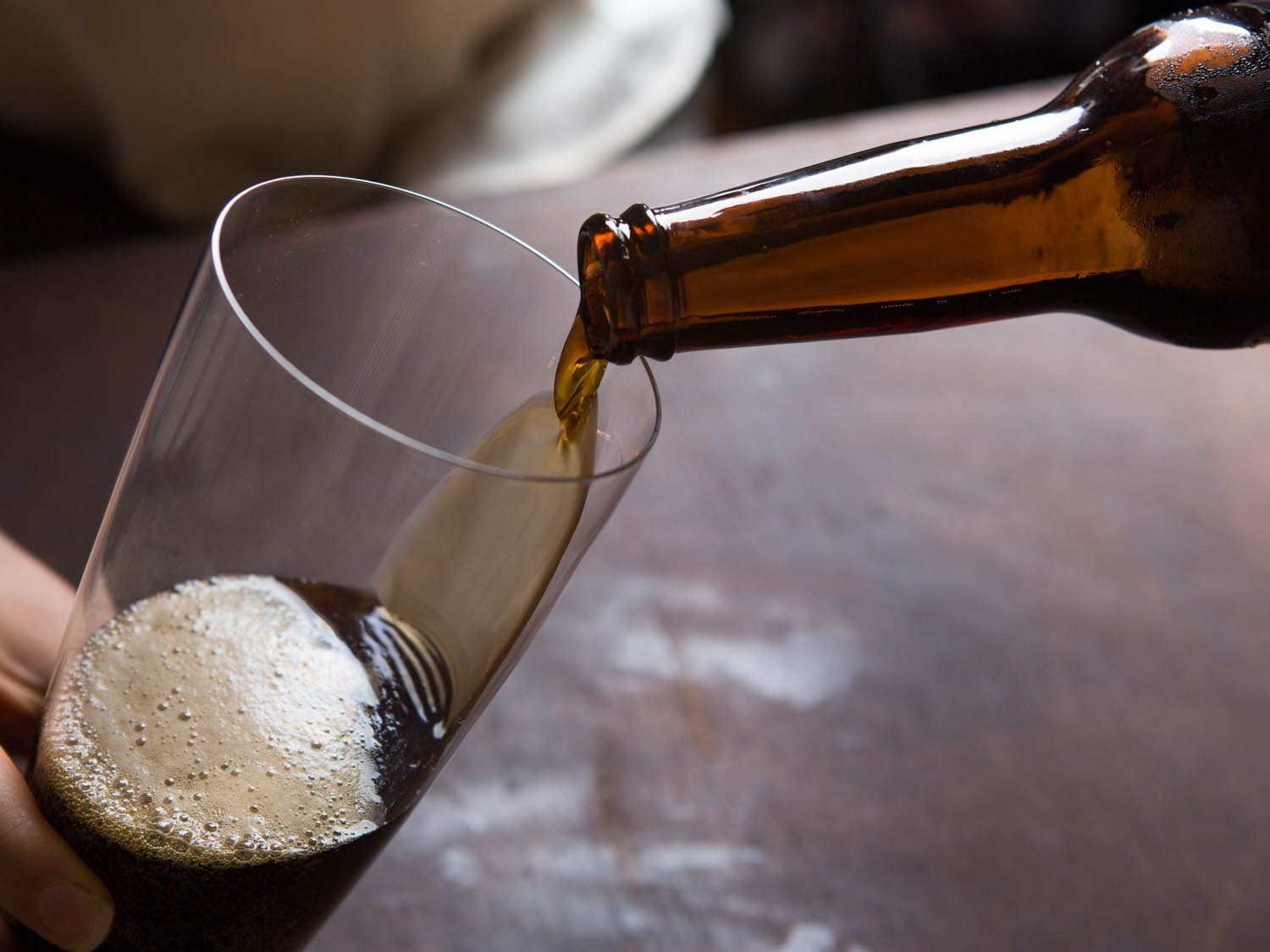 Pouring beer into a glass.