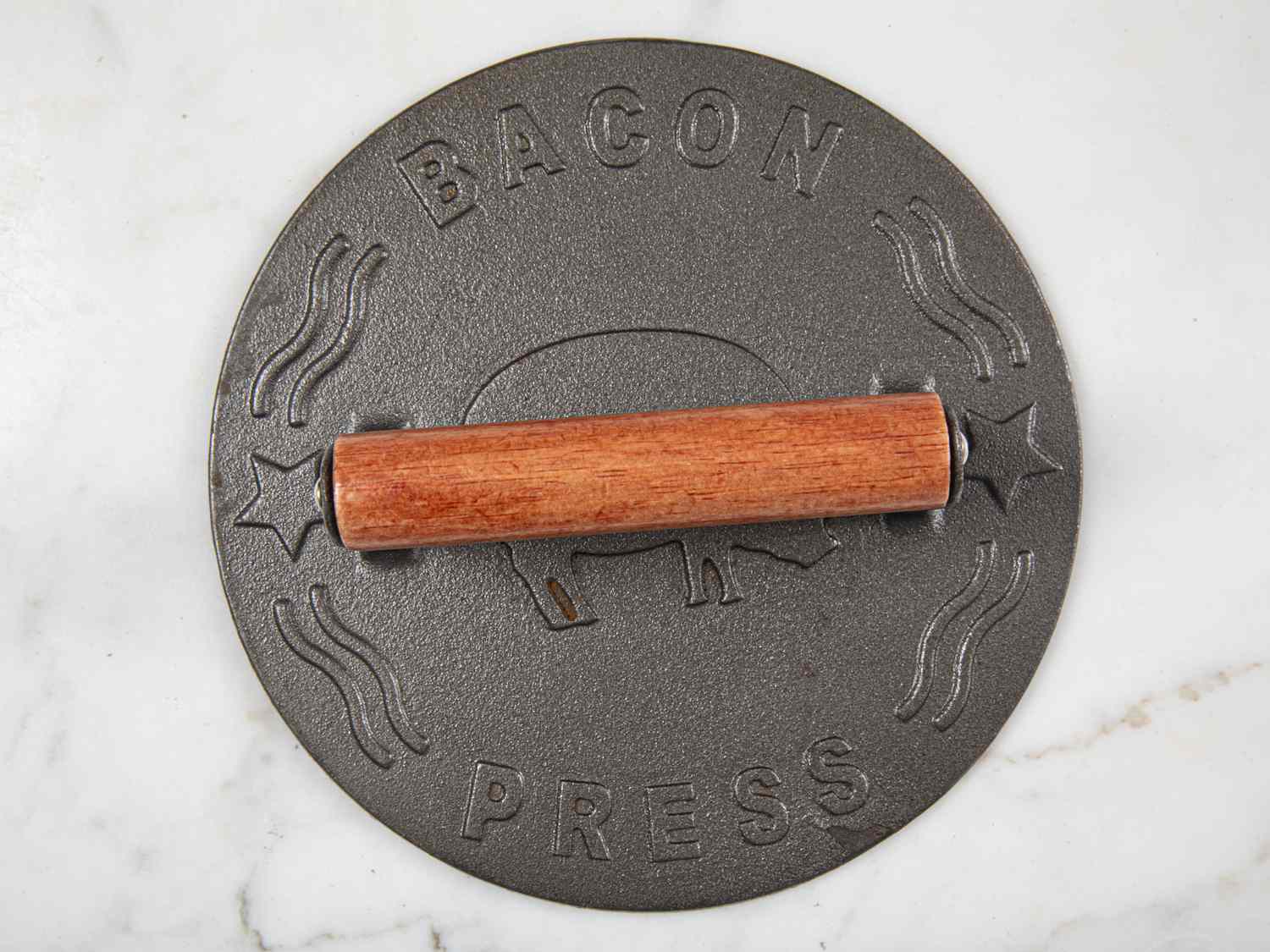 round grill press with wooden handle on marble surface